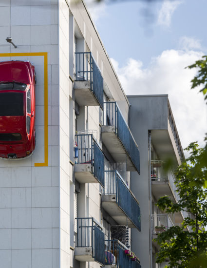 La Fiat 500 de Monsieur Bourgogne est stationnée à la verticale sur la façade d'un immeuble